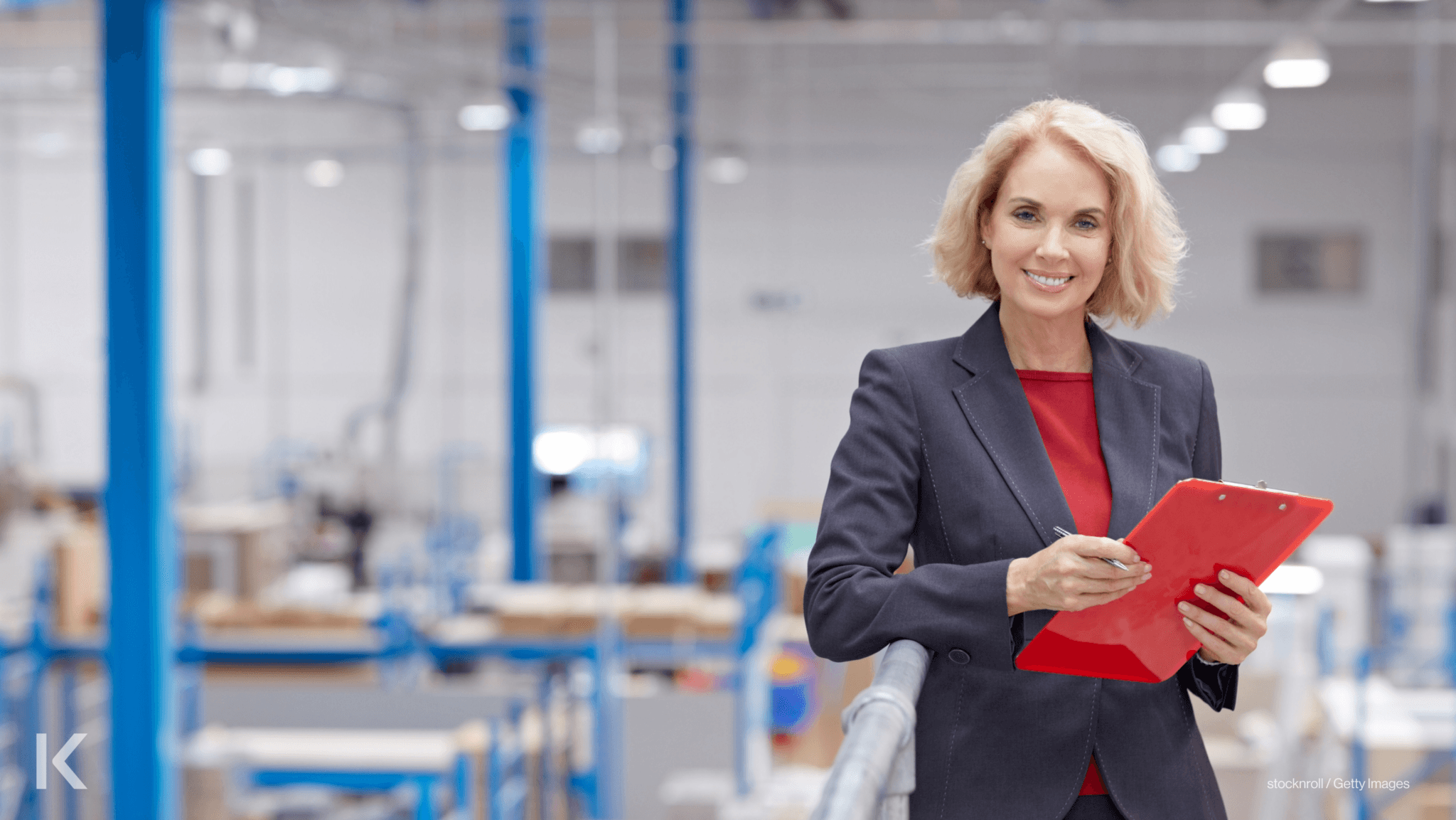 Senior businesswoman talking a walkthrough audit in warehouse building.
